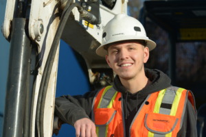 Smiling young man in construction gear
